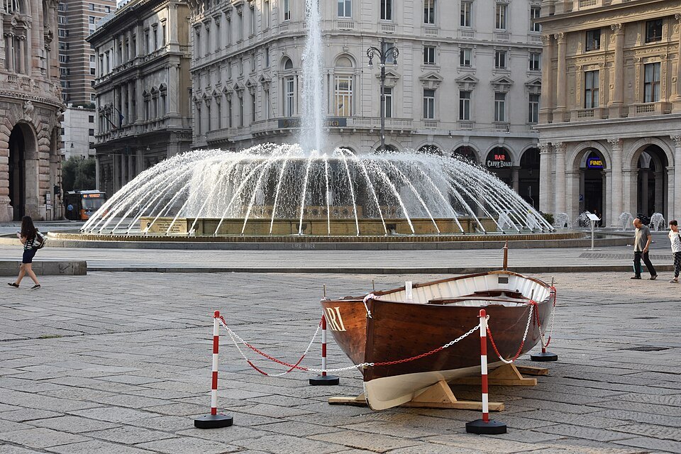 A wooden gozzo boat set beside the fountain for a festival