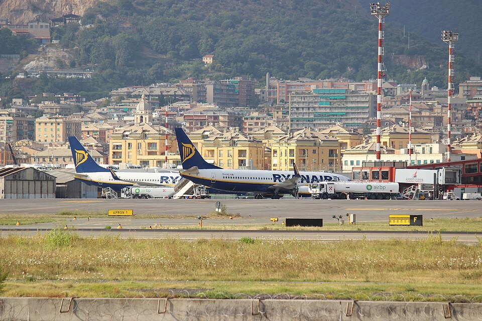 Aircraft at Genoa airport, the city and the hills rising behind