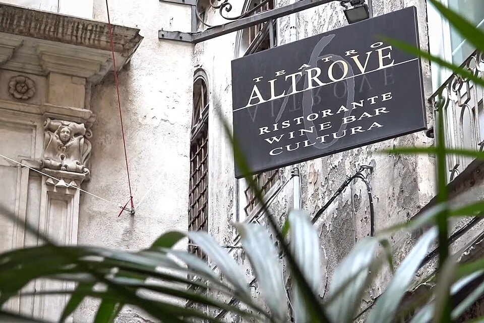 A restaurant sign hung in a lane of the old town