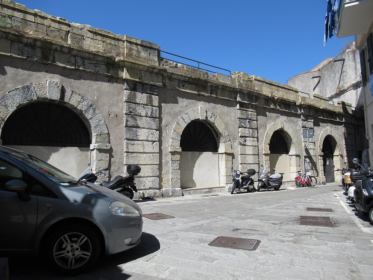 Arches of the old Molo walls, now a car park and a wall of the quarter