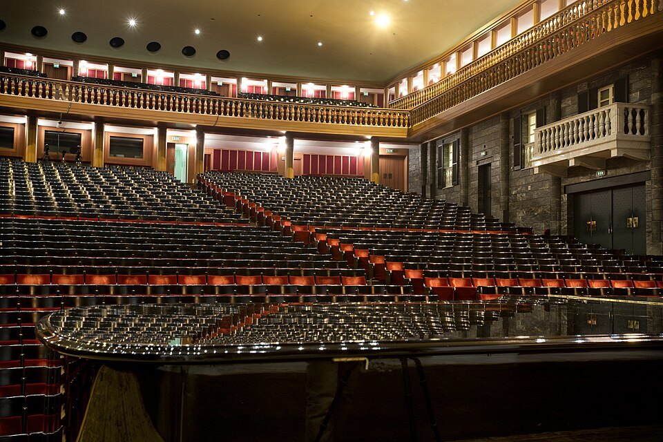 The gilded tiers and red seats of the Carlo Felice from the back of the stalls