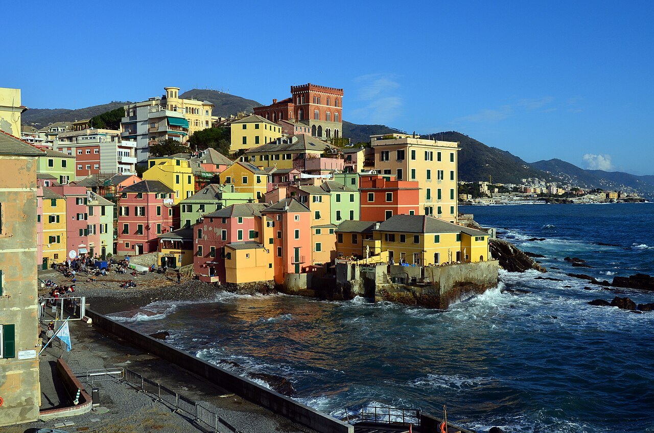 Boccadasse from the sea wall, painted houses stacked above the water