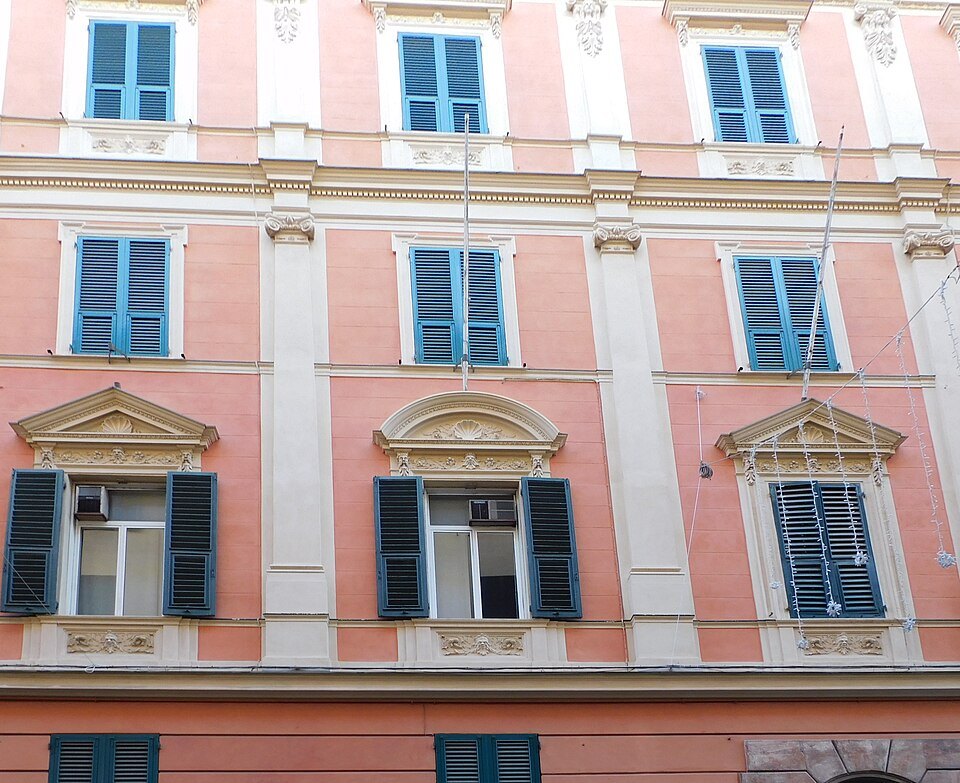 Painted window frames on a pink front in Via Cairoli
