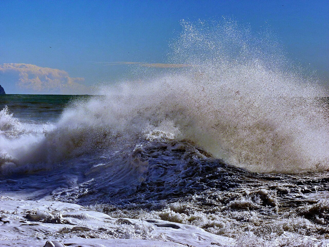 An autumn storm breaking over the rocks of the city shore