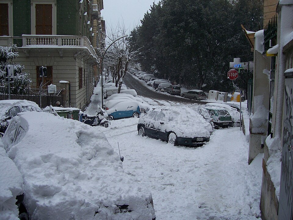 Snow on Via Pertinace, cars buried along the hillside street