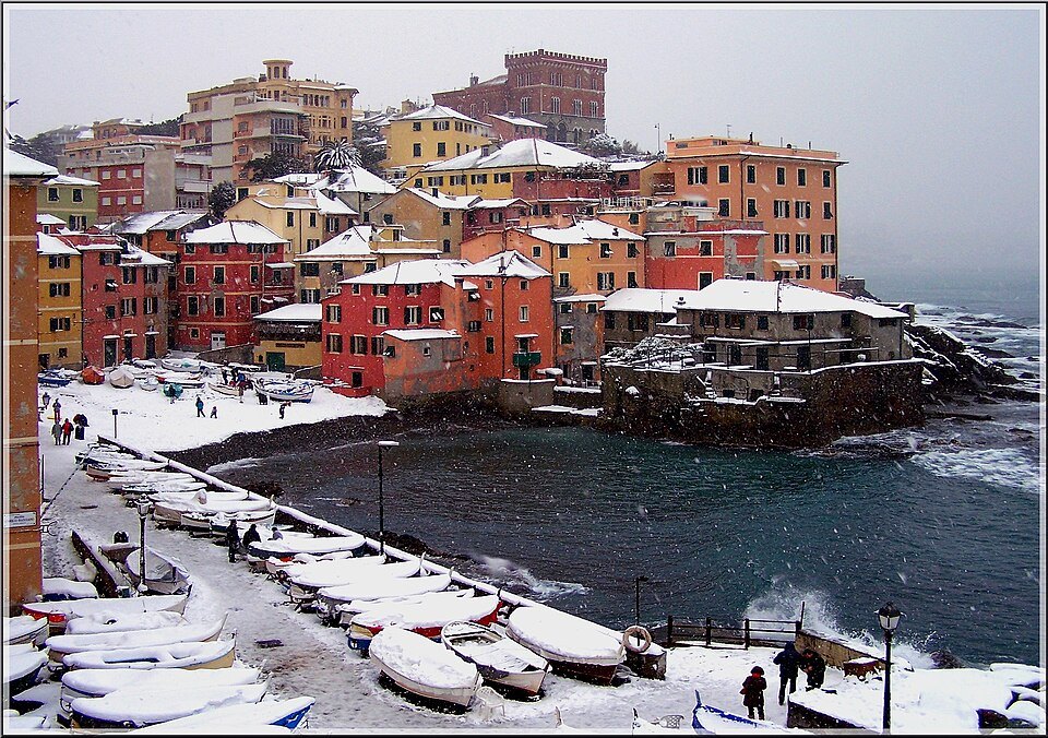 Boccadasse under snow, boats hauled up on the white pebbles
