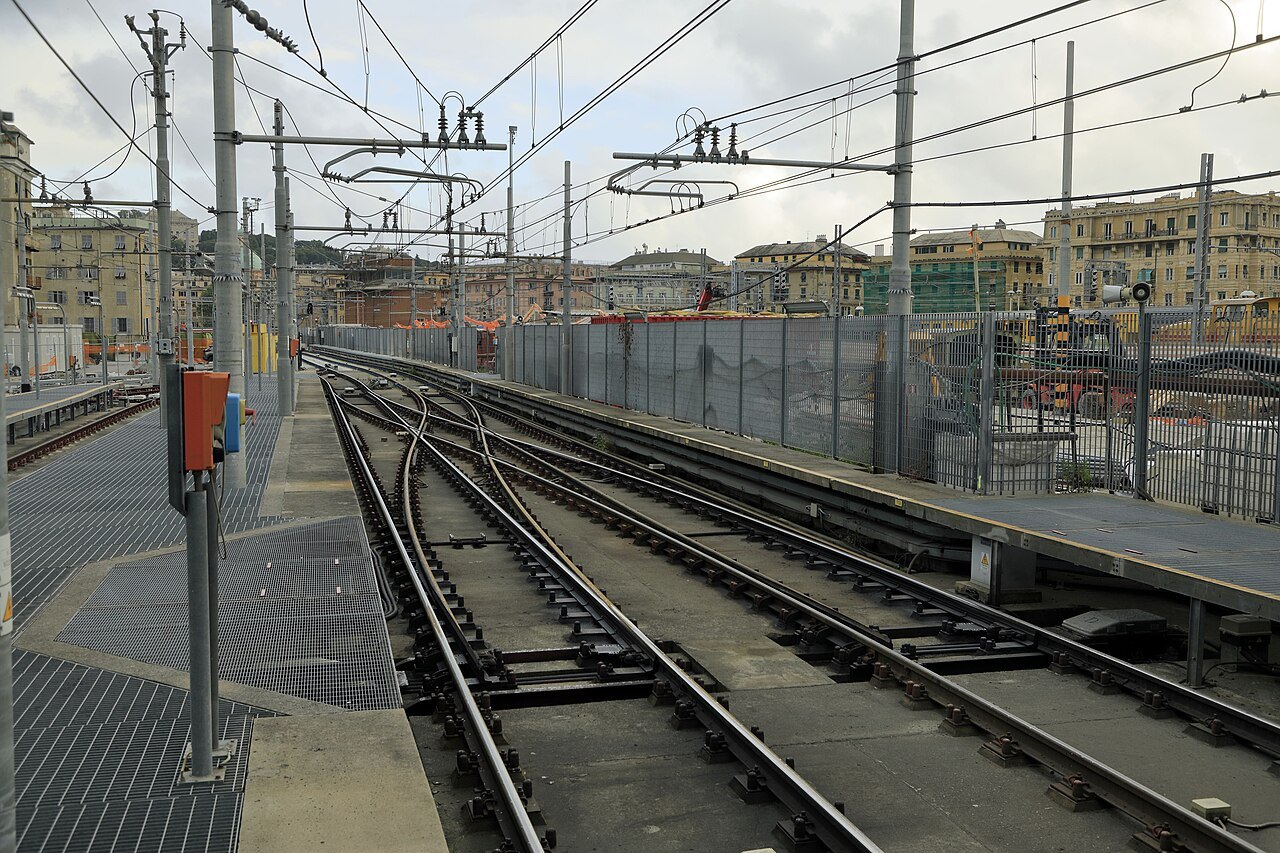 Metro tracks curving into the tunnel mouth beyond Brignole