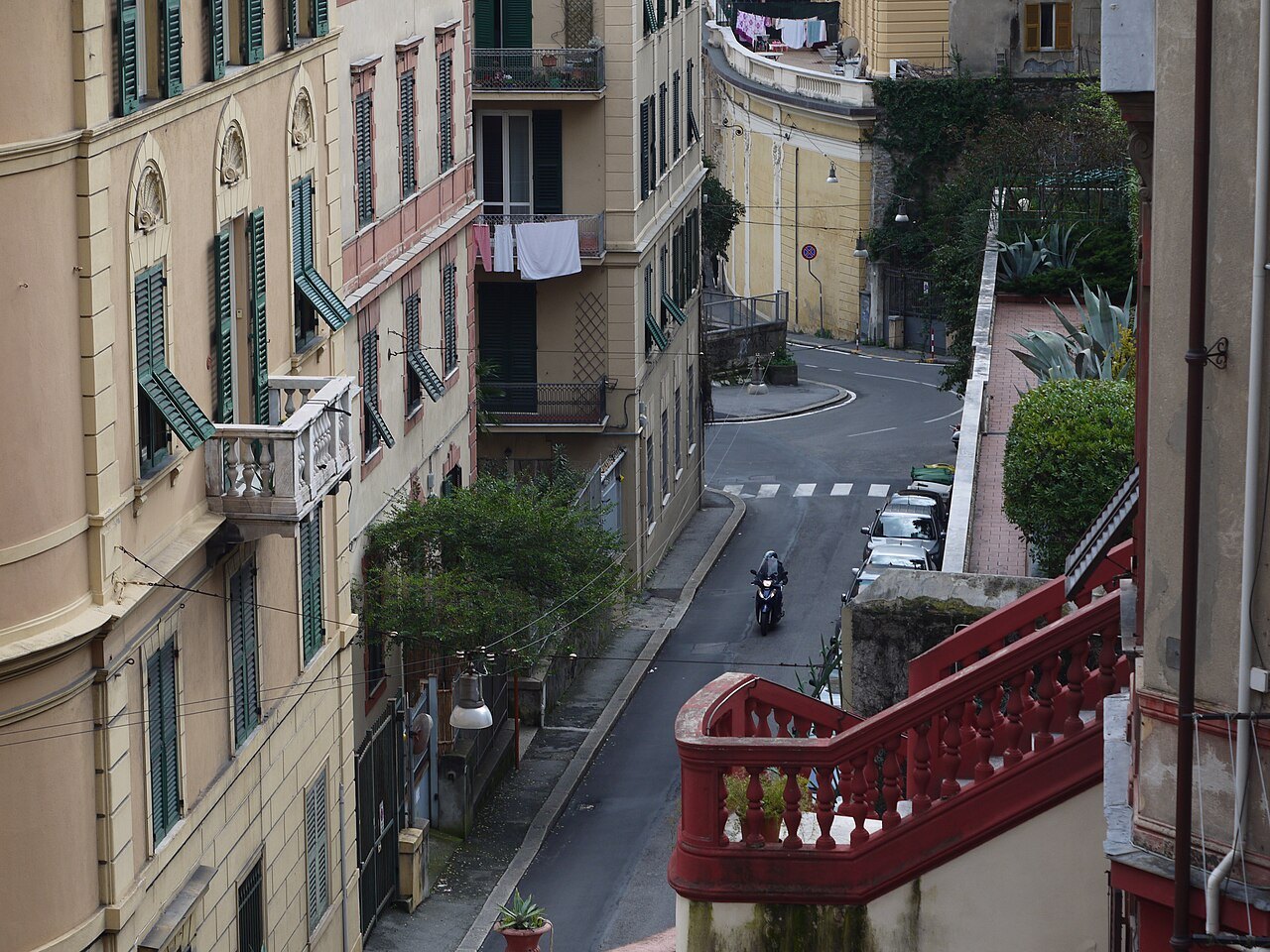A street below Castelletto with a red-railed stair dropping to the lower level