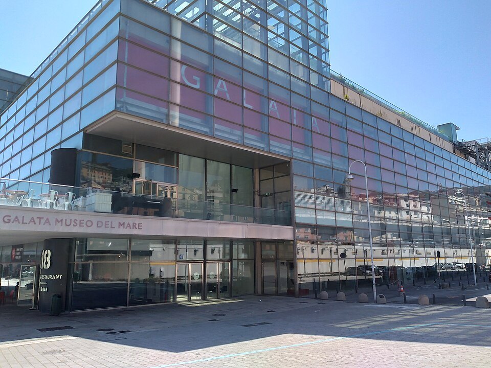 The museum's glazed flank, with the name across the upper floors