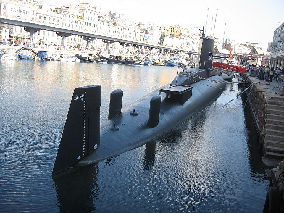 The submarine moored at the Porto Antico, the waterfront fronts behind it