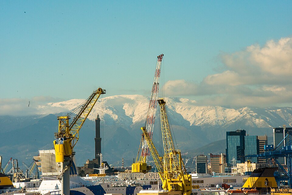 Harbour cranes and the snow-topped mountains behind the city
