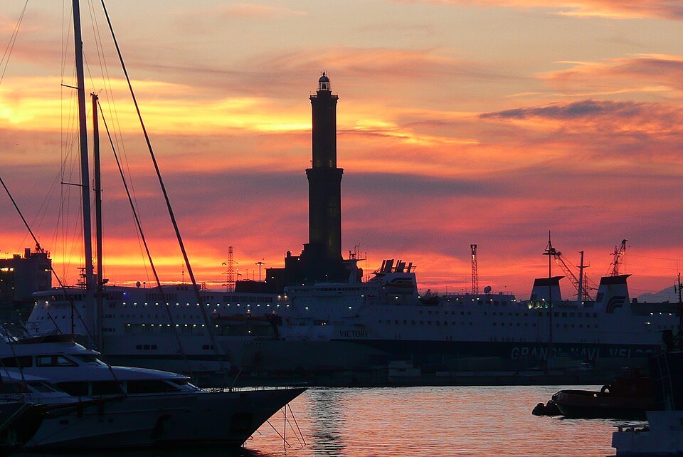 The Lanterna against a red evening sky above the harbour