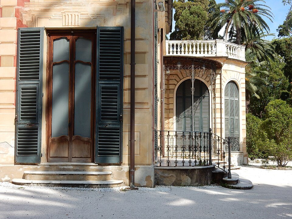 A shuttered doorway and window of a villa in the parks at Nervi
