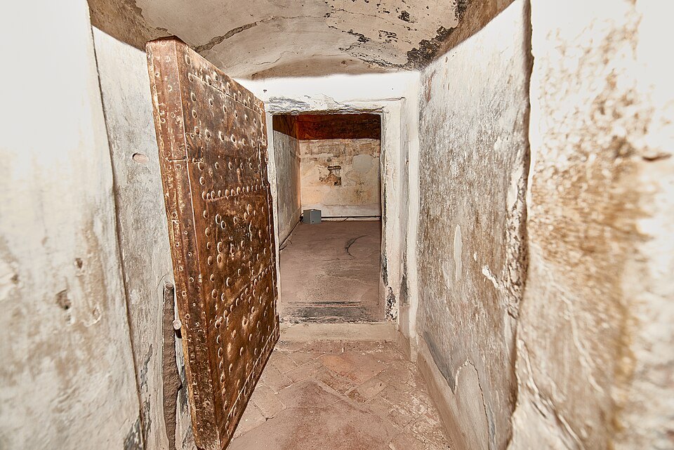 A cell inside the Grimaldina tower, its door and vault of bare stone
