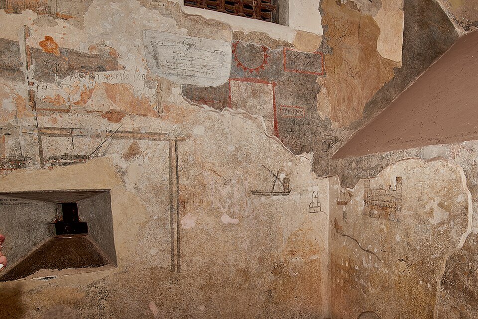 Prisoners' drawings and inscriptions on a wall inside the Grimaldina