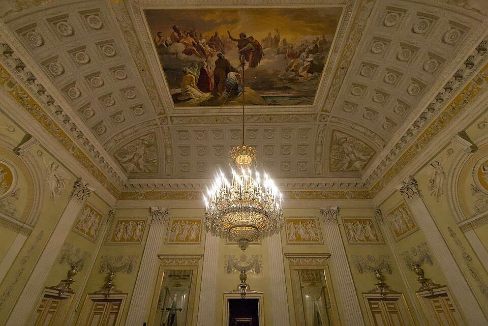 A chandelier under the painted ceiling of the Palazzo Reale's dancing hall
