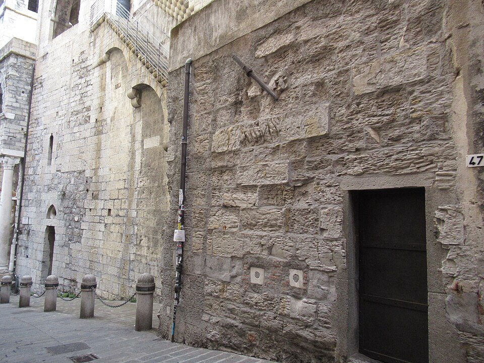 A stretch of the Barbarossa wall beside Porta Soprana, with a bricked door