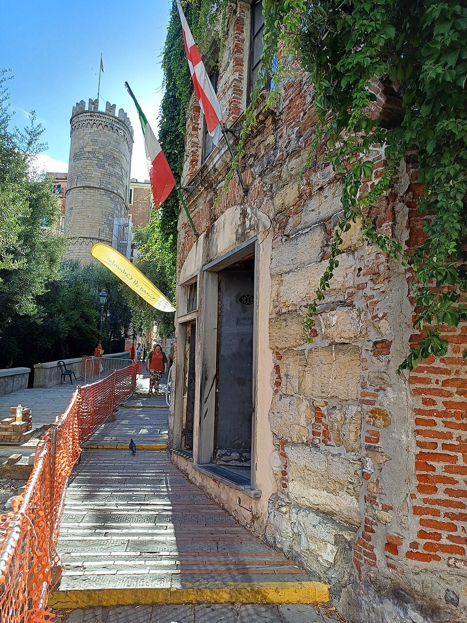 The Columbus house at the foot of the gate, flags above its door