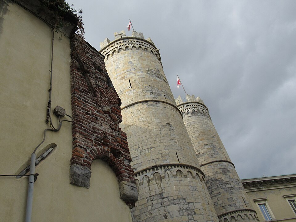 Porta Soprana from the garden side, the towers rising over the trees