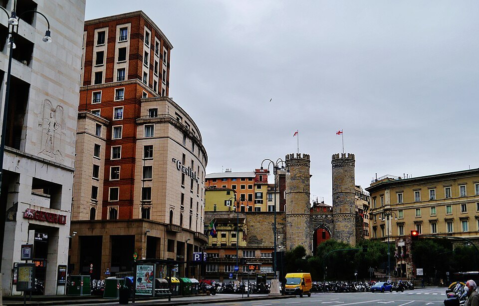 Porta Soprana's twin towers closing the view down the modern street