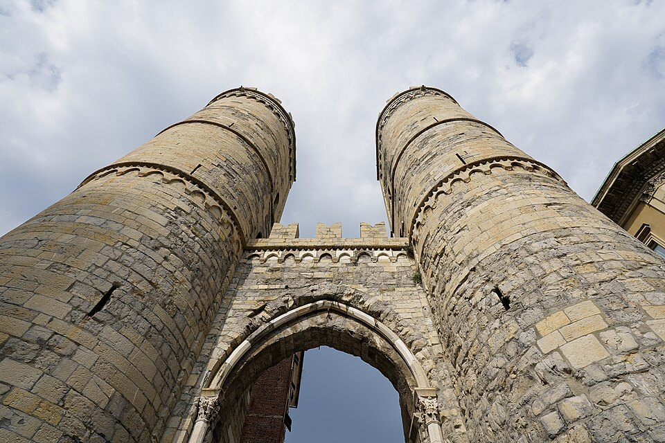 The twin towers of Porta Soprana above their arch, seen from directly below