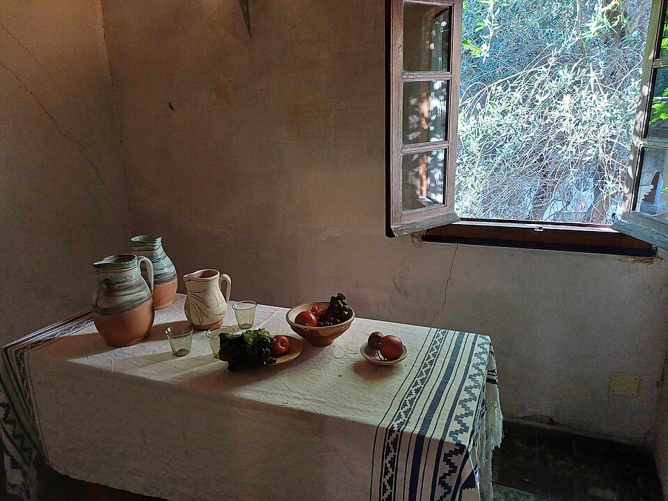 Inside the Columbus house: a table laid by the window of a small room