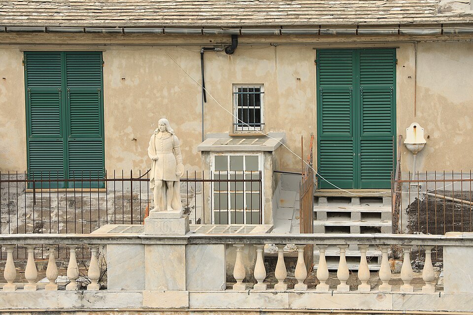 A statue set against the wall above the roofs of the cathedral