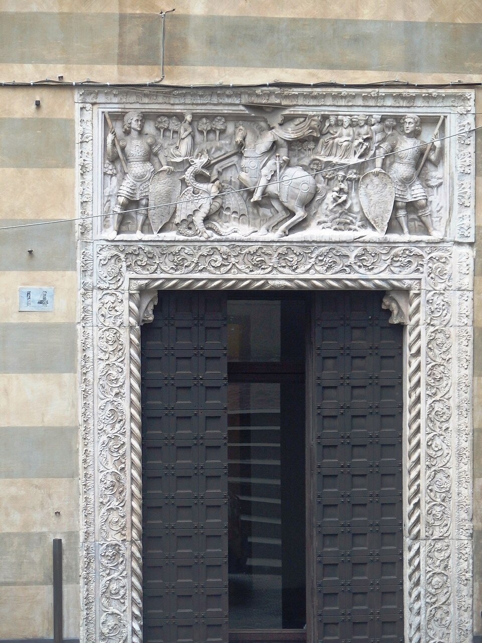 The carved slate lintel of Palazzo Giorgio Doria, in a lane of the old town