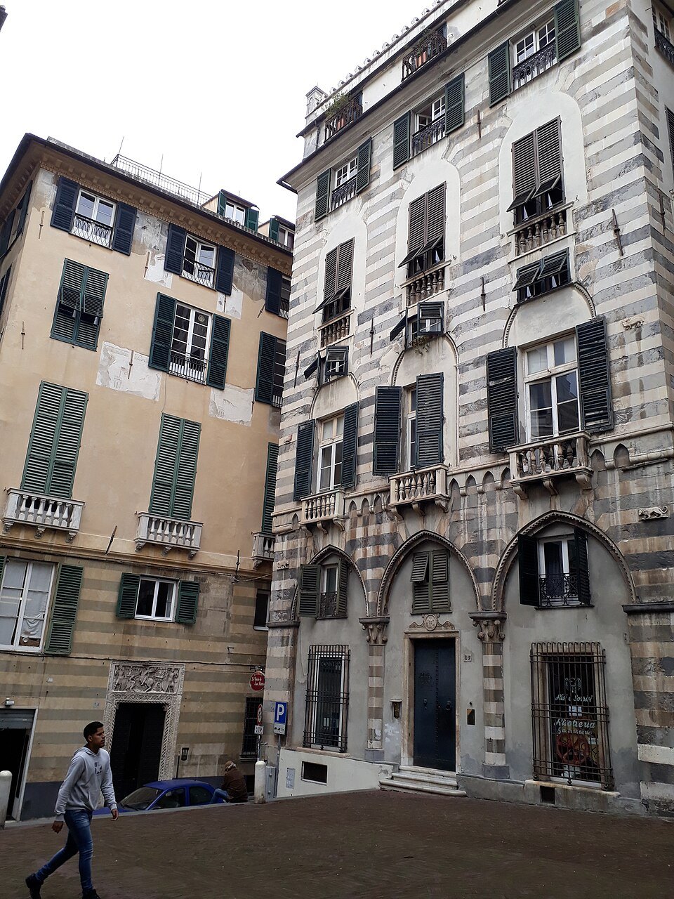 A striped Doria front on the little square, its pointed doorway set into the stone