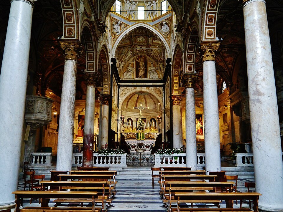 The nave of San Matteo, dark and banded, looking toward the altar
