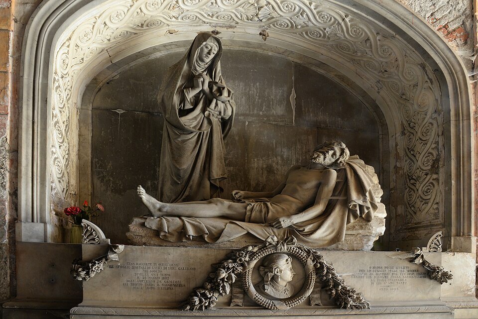 A mourning figure reclining on a tomb, carved in white marble