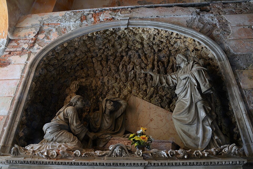 A grieving figure carved over a tomb in the Staglieno galleries