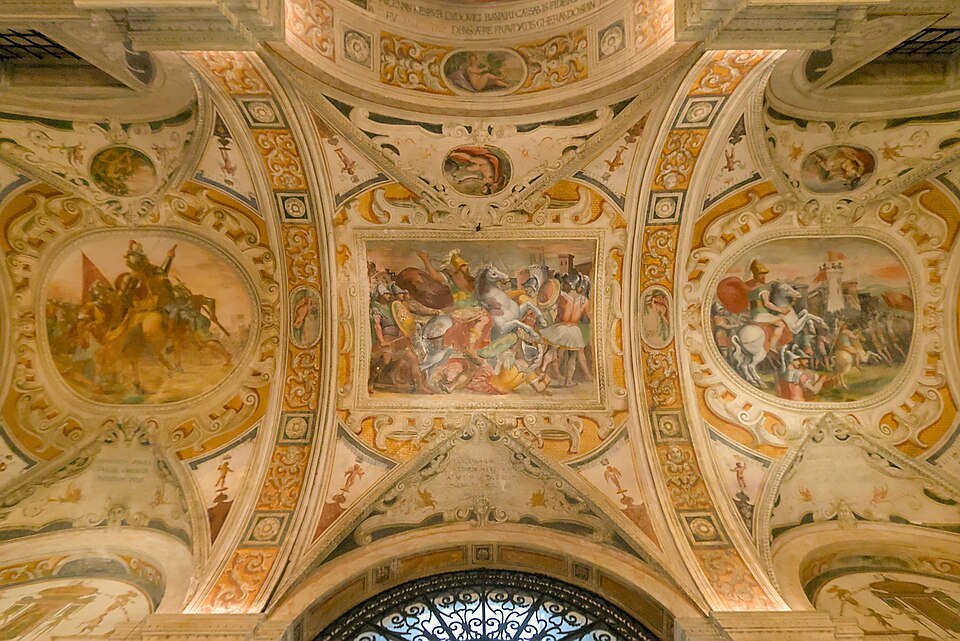 A painted vault in a Rolli palace, battle scenes framed in gilded stucco